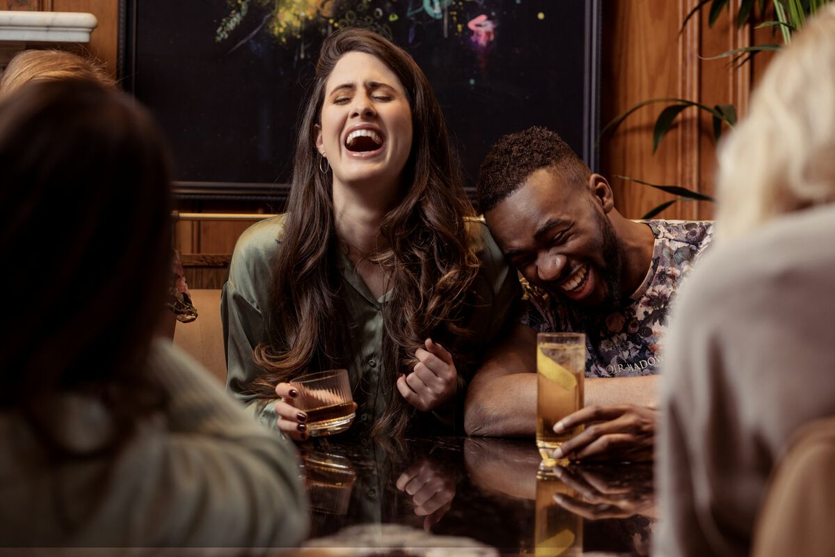 Friends around a table in a warm pub snug
