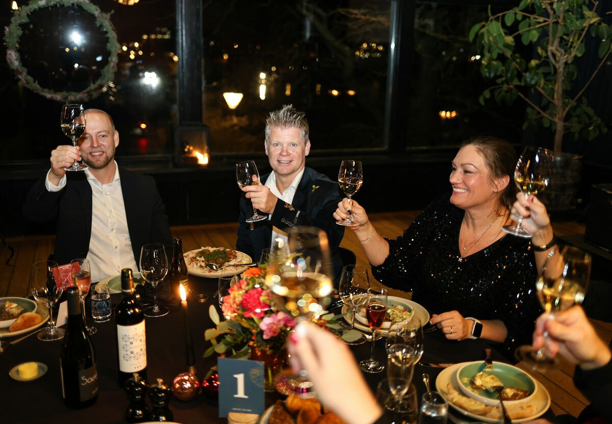 Friends raising their glasses at a dinner table